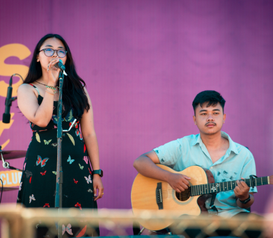 Student singing on stage as part of Kathford Sparks festival festivities