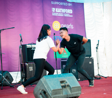 Student dancing on stage as part of Kathford Sparks festival festivities