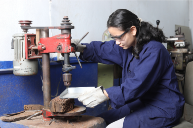 Electronics lab student using a large equipment for practical work