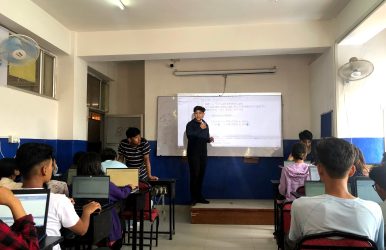 Instructor demonstrating techniques in C-based computer graphics to participants