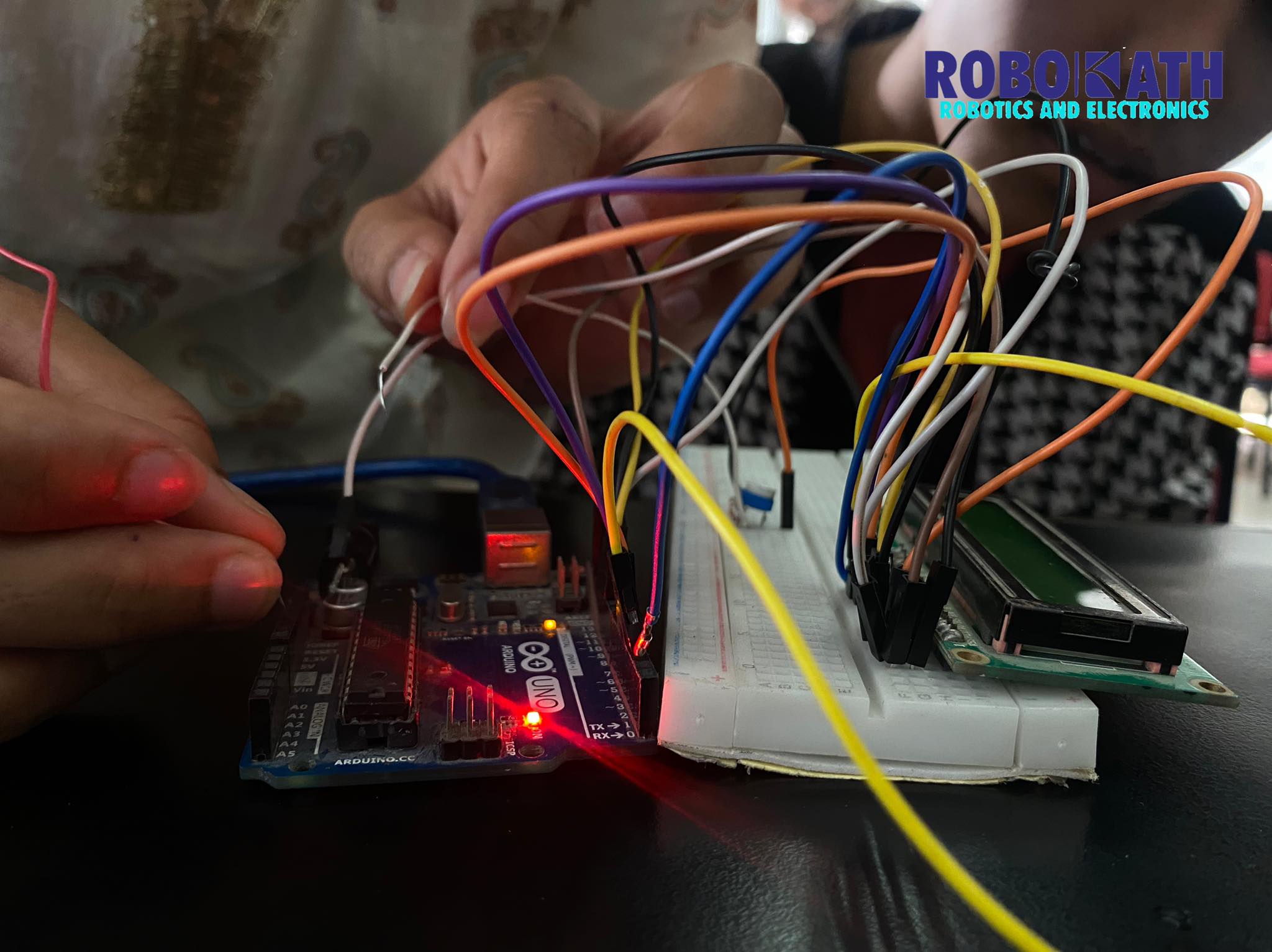 Students learning Arduino components and basic coding techniques.