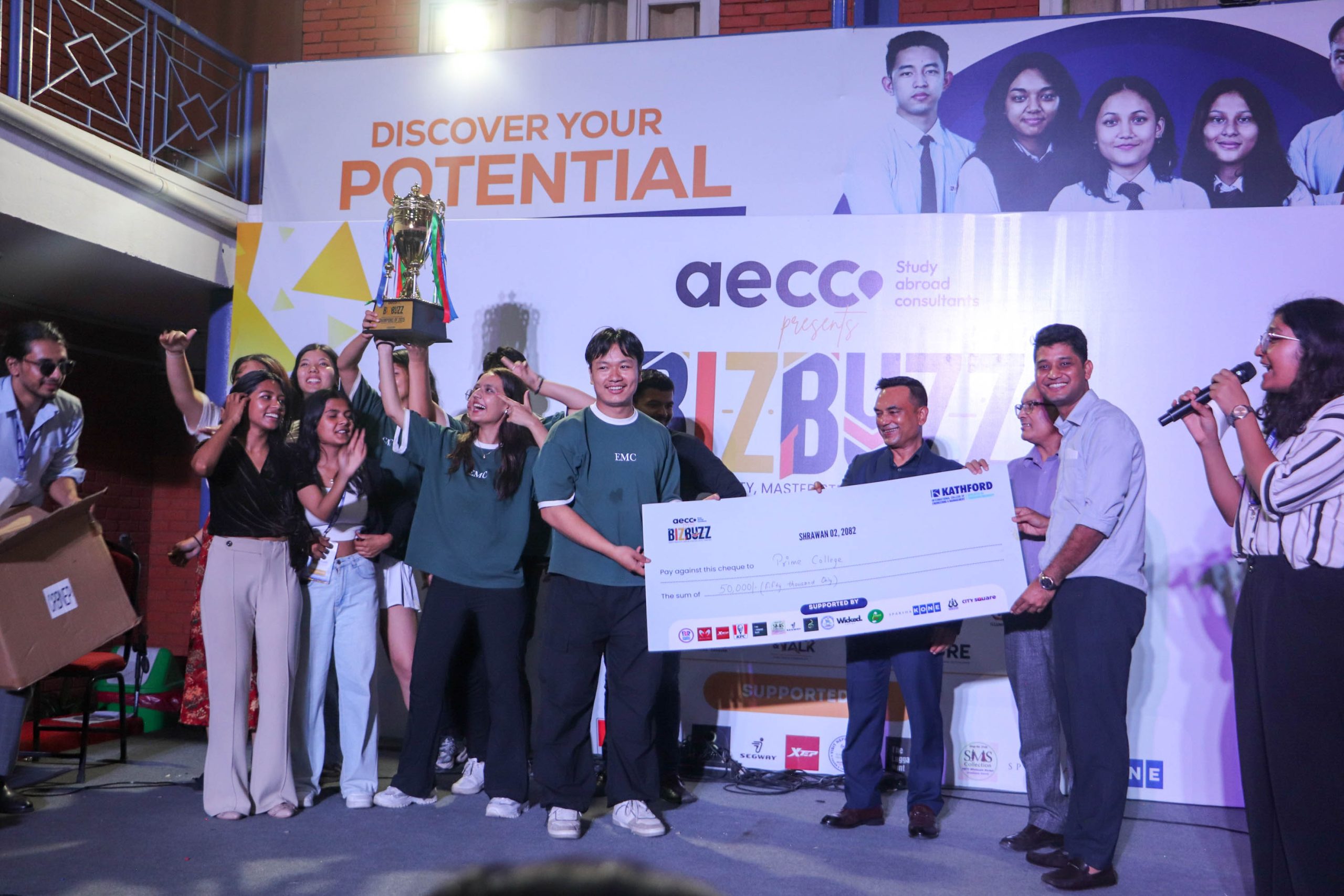 BizBuzz event winner holding grand cash price along with trophy