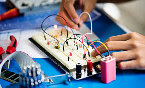 Student designing electrical circuit