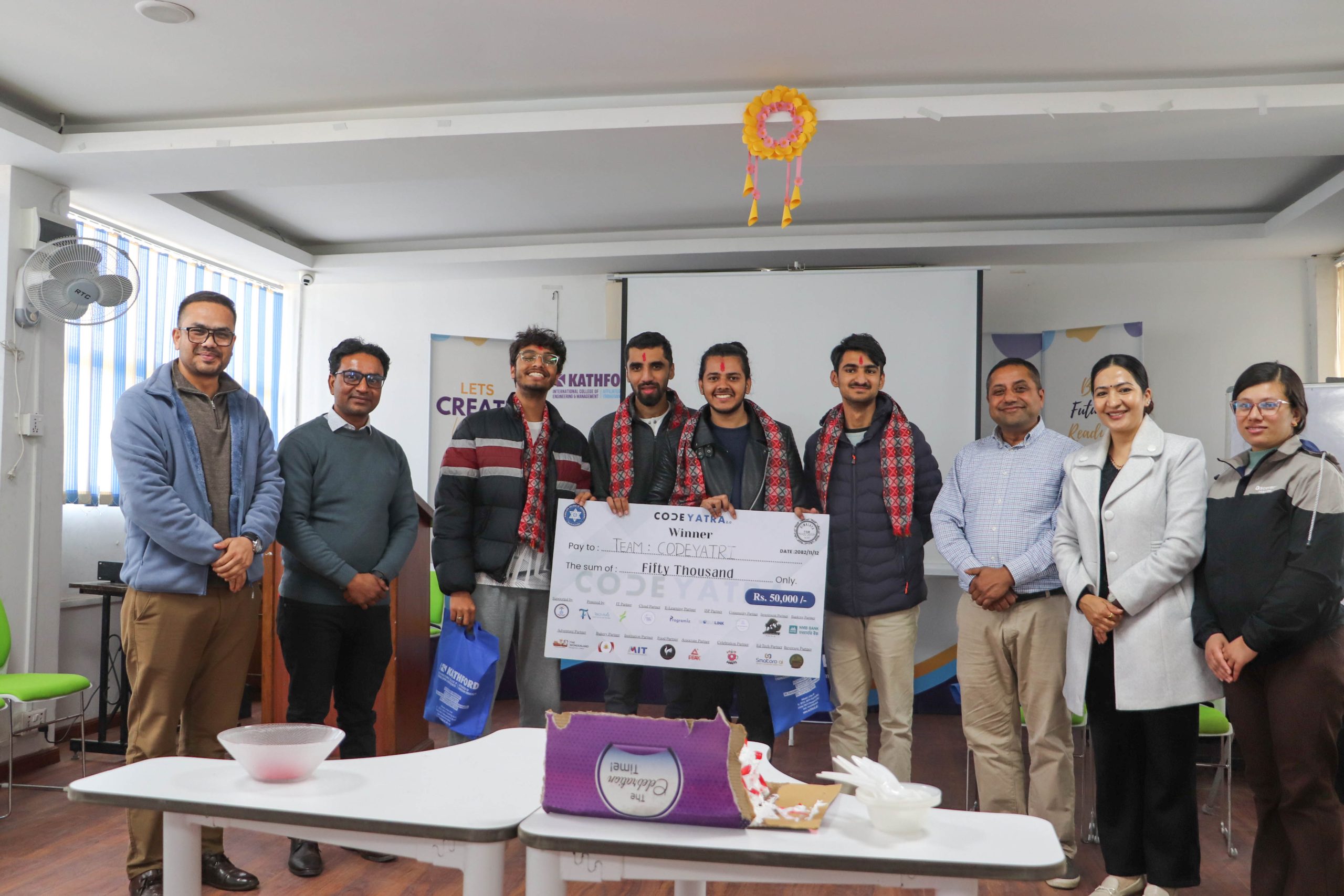 Team CodeYatra winners holding prize cheque at celebration event.