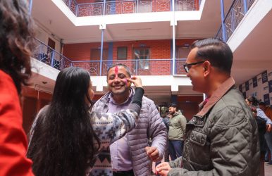 Applying Holi colors to the principal during Holi Celebration