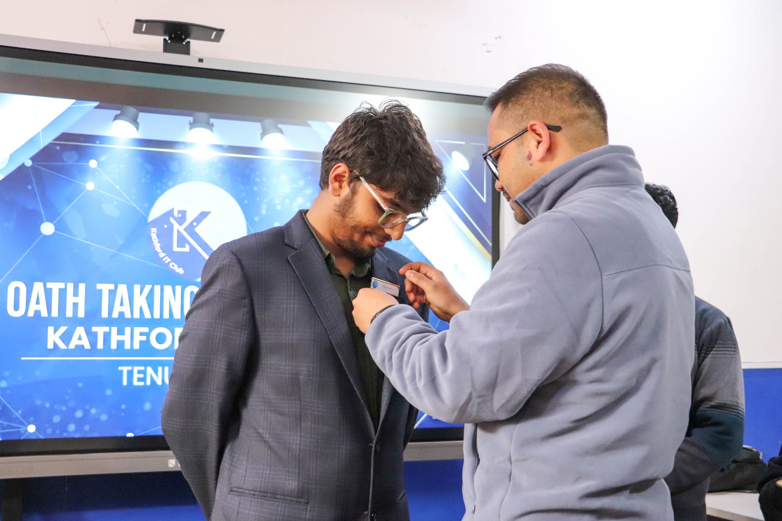 Badge pinning to the new president during Kathford IT Club oath taking ceremony.