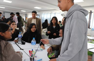 Student negotiating to sell a pencil – BBA for entrepreneurship learning activity.