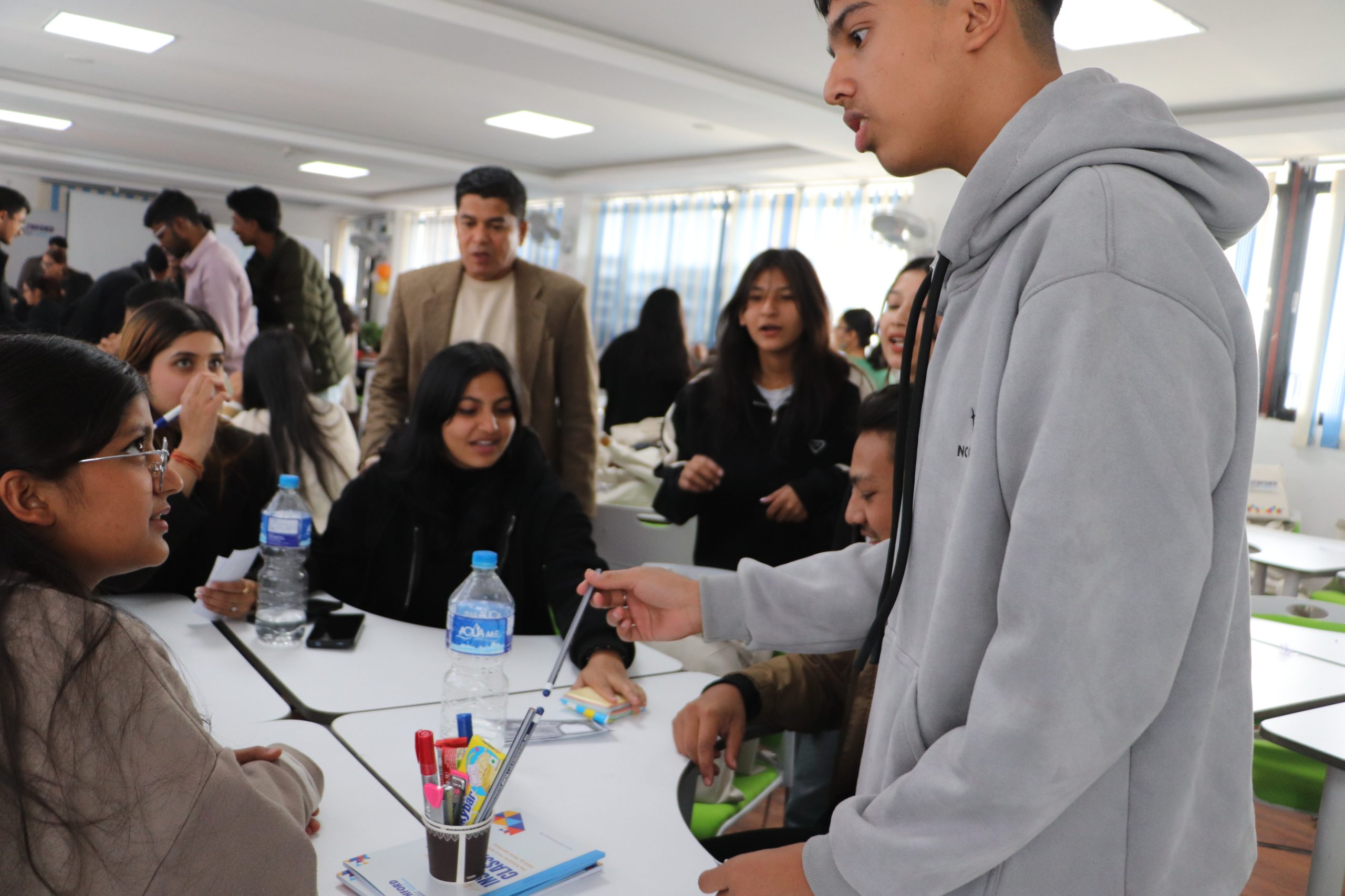 Student negotiating to sell a pencil – BBA for entrepreneurship learning activity.