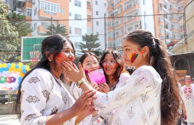 Students applying Holi colors to each other during the Holi celebration