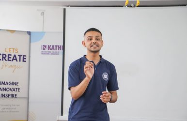Student speaking confidently during a presentation at KathTalk event